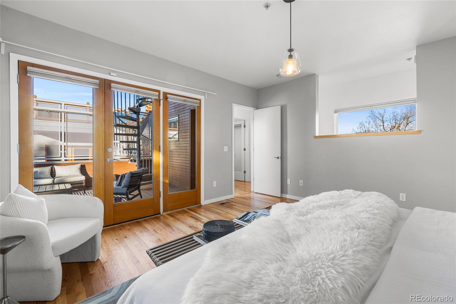 1675 Boulder Street Denver, CO 80211 - Photo 22 of 39 a bedroom with a large bed and a couch next to a window