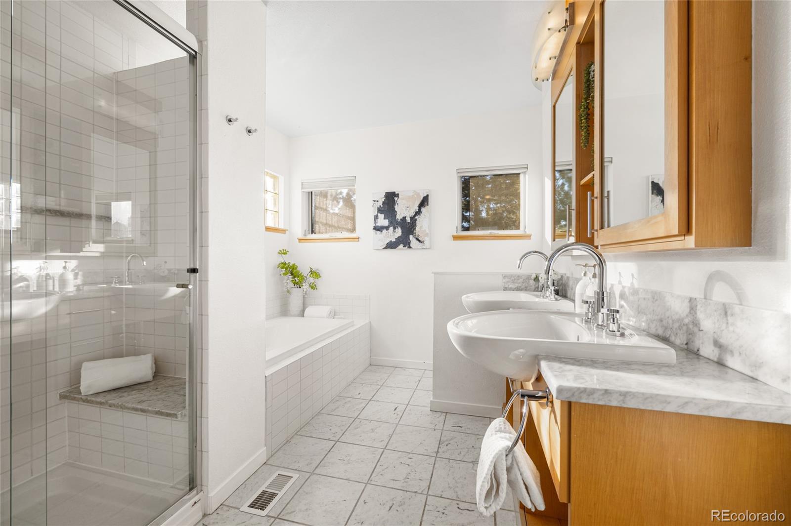 1675 Boulder Street Denver, CO 80211 - Photo 23 of 39 a bathroom with a sink a toilet and shower