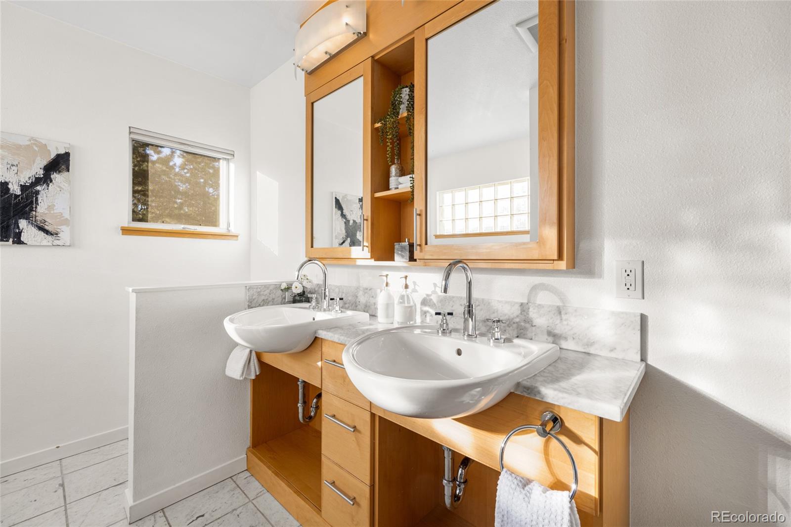 1675 Boulder Street Denver, CO 80211 - Photo 24 of 39 a bathroom with a sink and a mirror