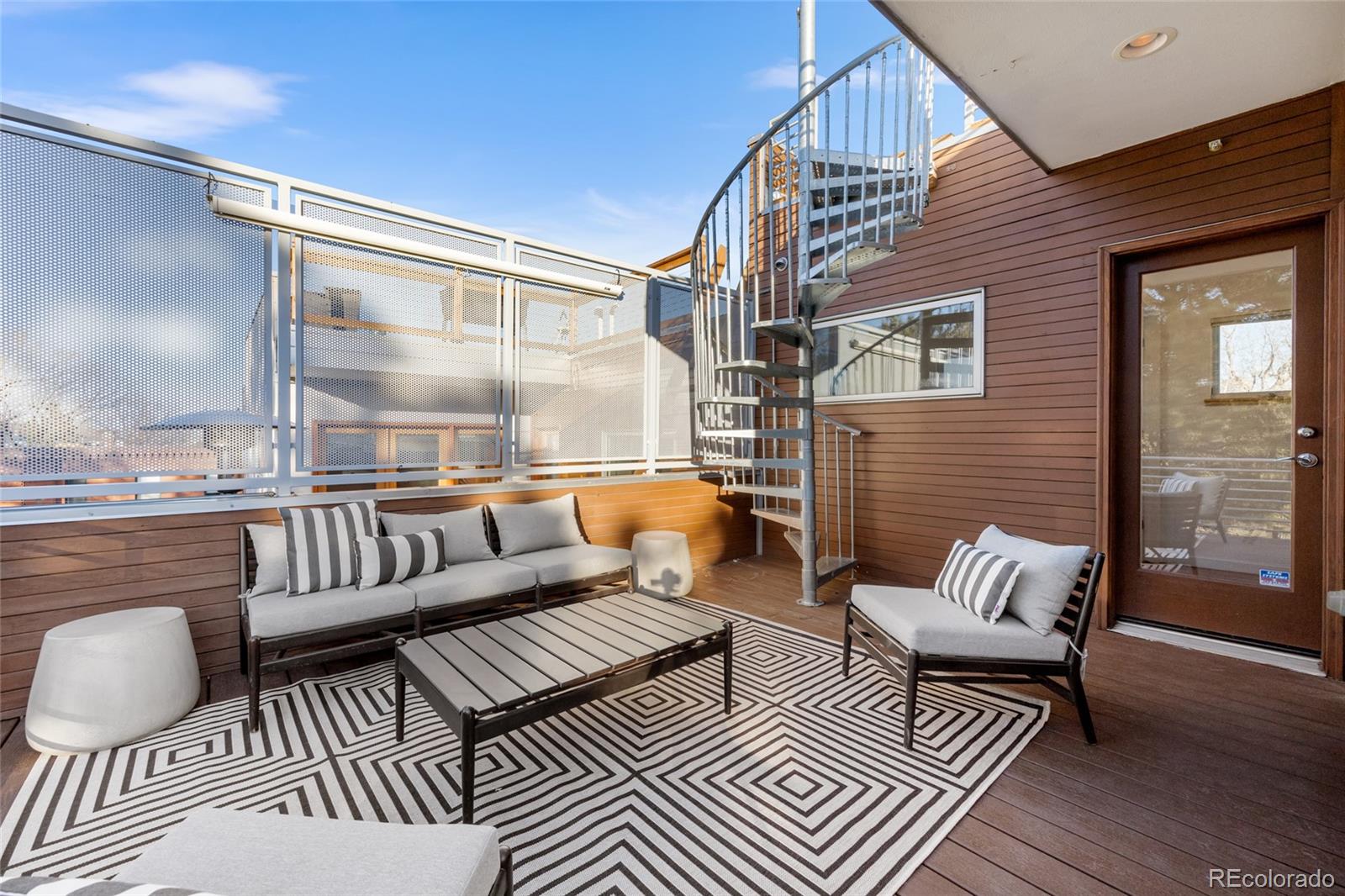 1675 Boulder Street Denver, CO 80211 - Photo 28 of 39 a balcony with furniture and wooden floor