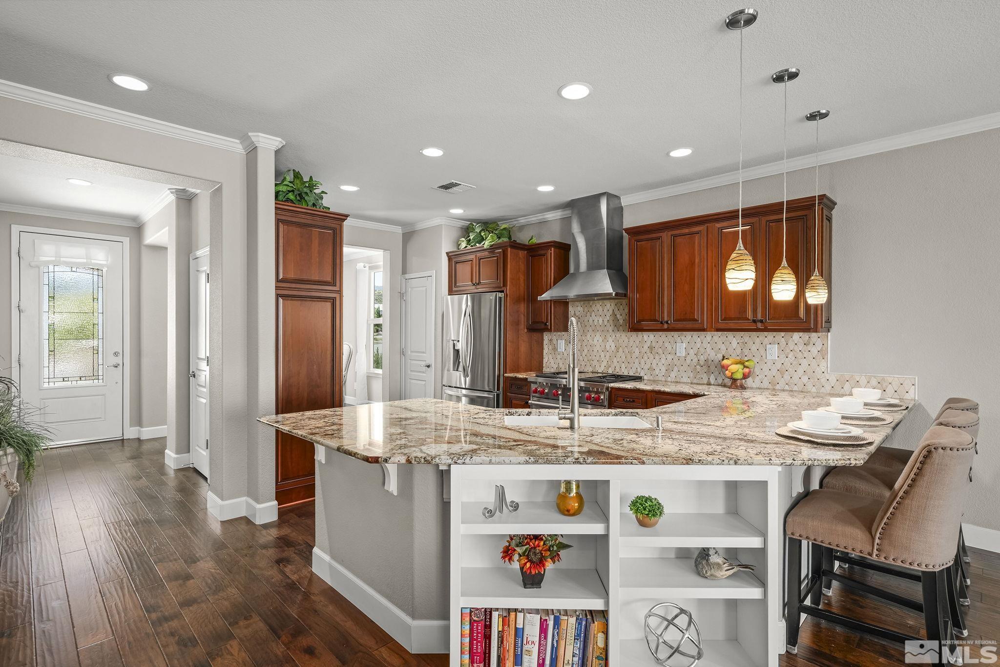9092 Kenton Trail Reno, NV 89523 - Photo 8 of 34 a view of kitchen island a sink and a refrigerator