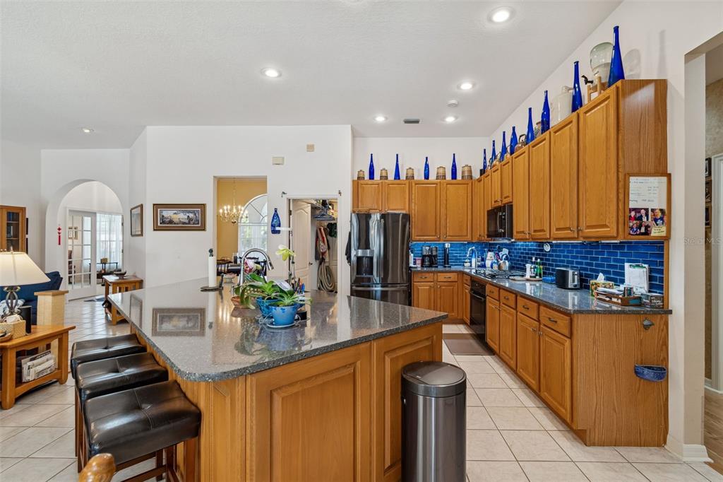 928 Oakview Road Tarpon Springs, FL 34689 - Photo 13 of 75 a kitchen with stainless steel appliances kitchen island granite countertop a sink and cabinets