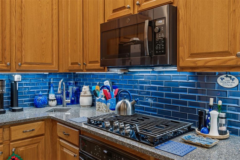 928 Oakview Road Tarpon Springs, FL 34689 - Photo 15 of 75 a kitchen with granite countertop stove and cabinets