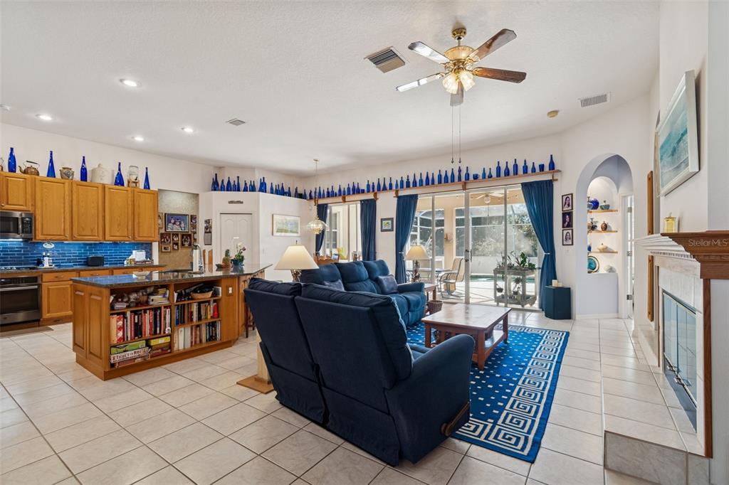 928 Oakview Road Tarpon Springs, FL 34689 - Photo 20 of 75 a living room with furniture a flat screen tv and a large window