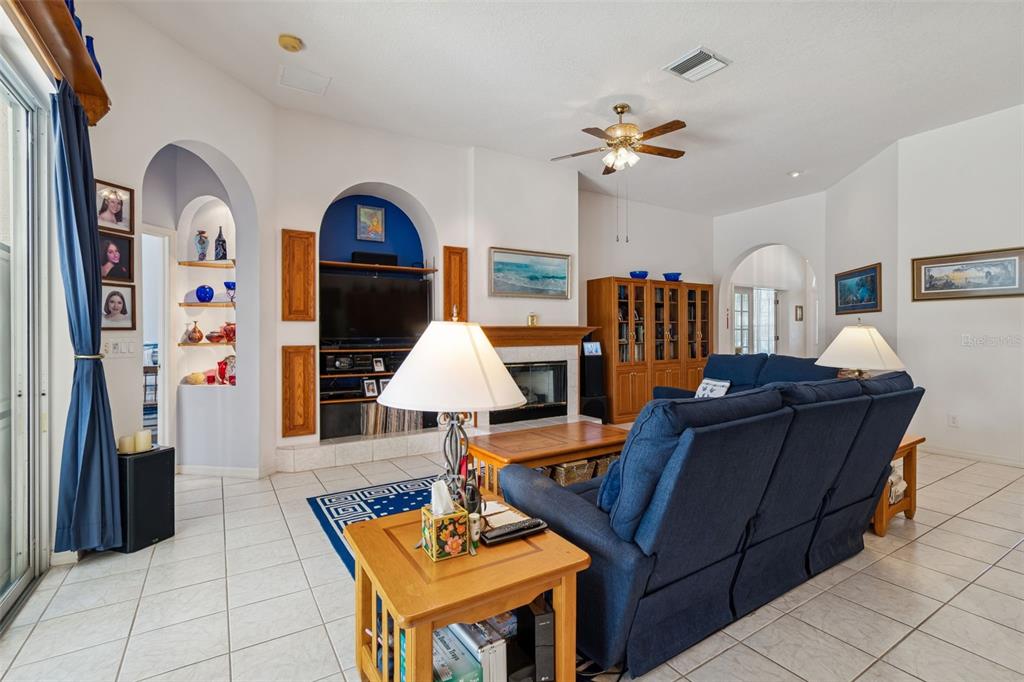 928 Oakview Road Tarpon Springs, FL 34689 - Photo 22 of 75 a living room with furniture a rug and a chandelier