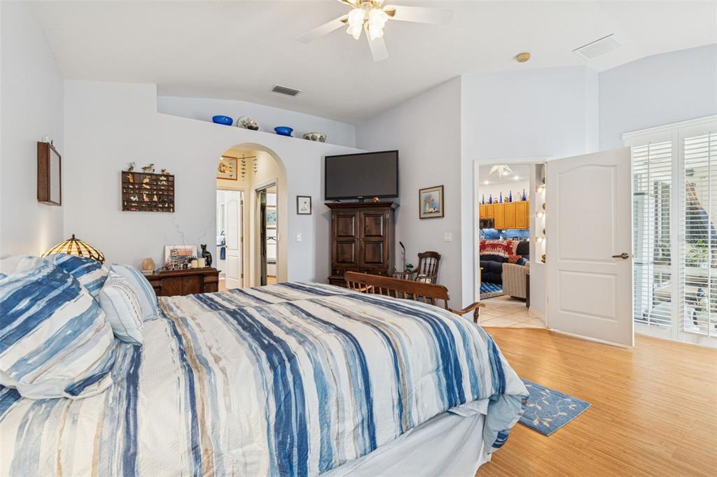 928 Oakview Road Tarpon Springs, FL 34689 - Photo 28 of 75 a bedroom with bed and a chandelier