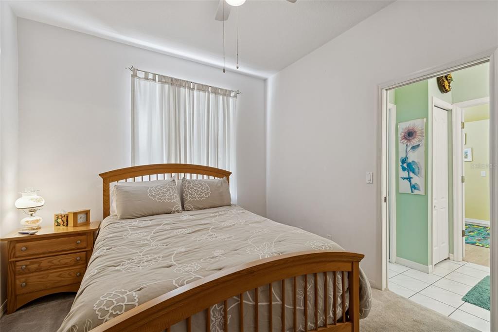 928 Oakview Road Tarpon Springs, FL 34689 - Photo 34 of 75 a bedroom with a large bed and a chandelier