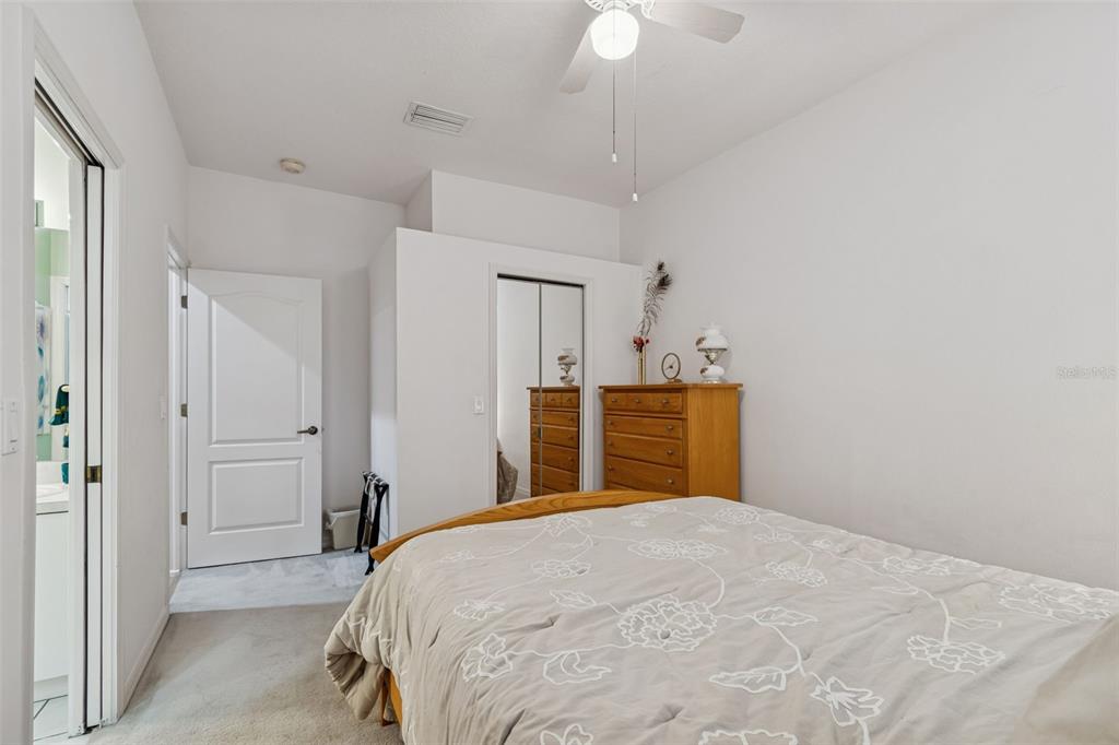 928 Oakview Road Tarpon Springs, FL 34689 - Photo 35 of 75 a bedroom with a bed and a chandelier