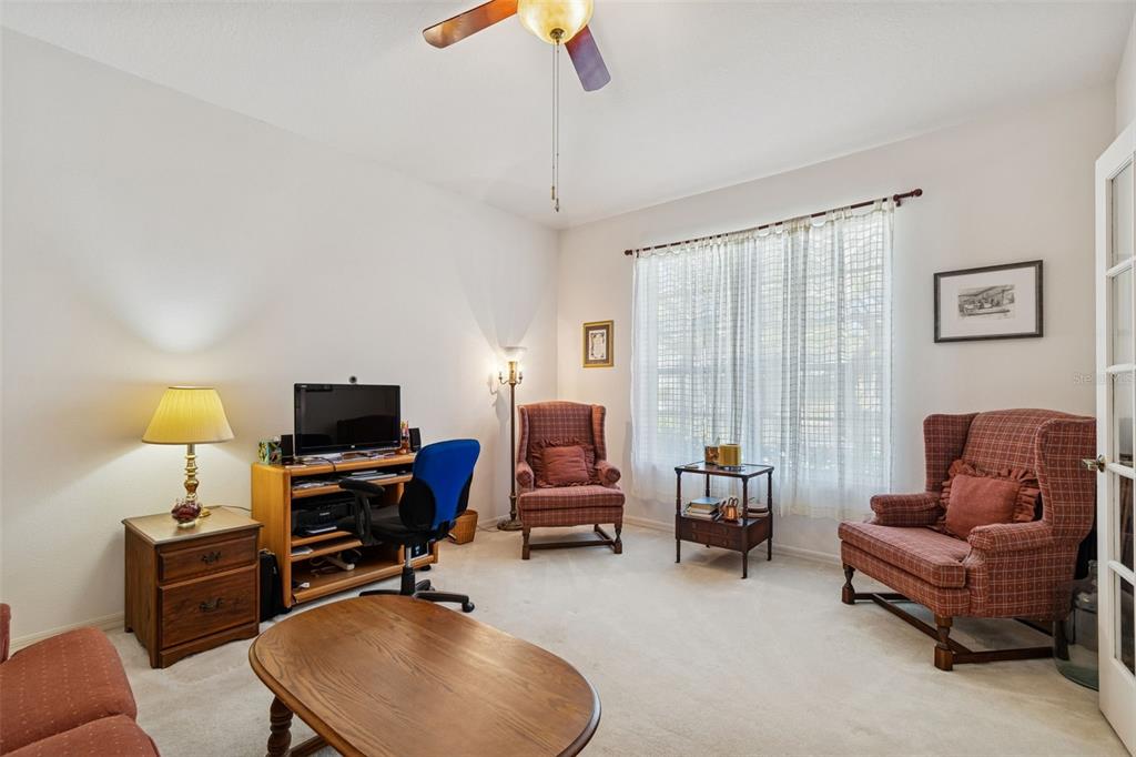 928 Oakview Road Tarpon Springs, FL 34689 - Photo 7 of 75 a living room with furniture a flat screen tv and a window