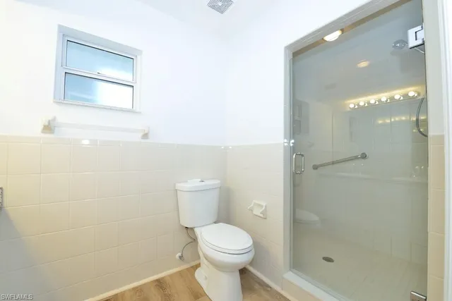 a bathroom with a toilet sink and shower
