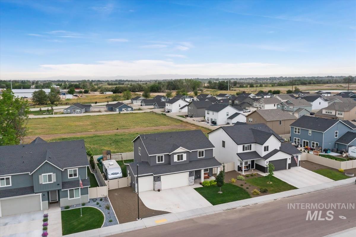 815 Knowledge Street Middleton, ID 83644 - Photo 3 of 49 Contemporary suburban streetscape featuring multiple two-story residences with dark shingle roofing