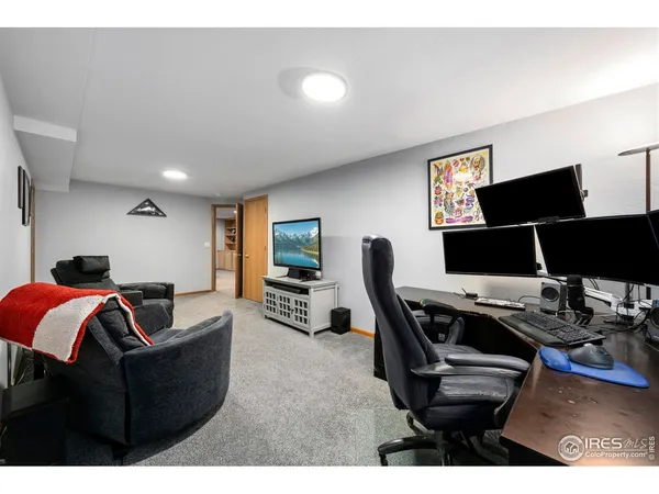 a living room with furniture and a flat screen tv with wooden floor