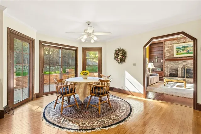 a view of a dining room with furniture wooden floor and chandelier