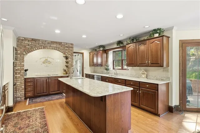 a kitchen with a stove a sink a refrigerator and wooden cabinets