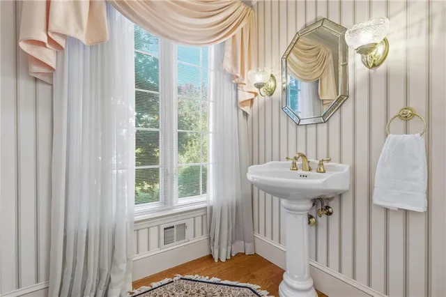 a bathroom with a sink a mirror and bathtub