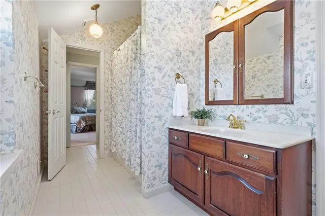 a bathroom with a sink a mirror and a shower