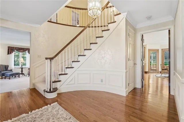a view of entryway and hall with wooden floor