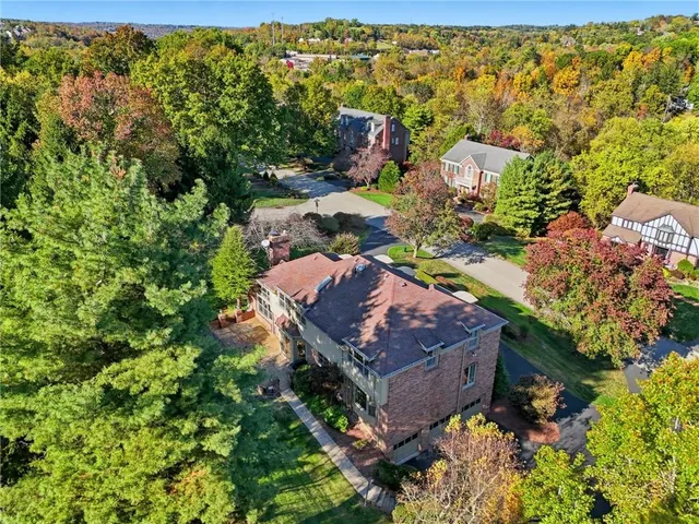 an aerial view of a house with a yard basket ball court