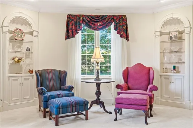 a living room with furniture a wooden floor and a window