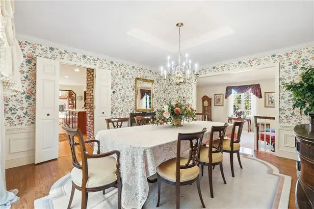 a view of a dining room with furniture and chandelier