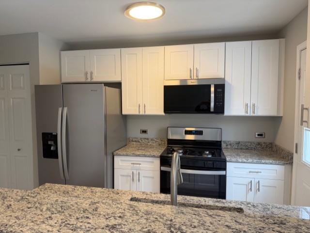 588 Nantucket Way, Unit 2 Island Lake, IL 60042 - Photo 2 of 29 a kitchen with stainless steel appliances granite countertop a stove a refrigerator and a microwave