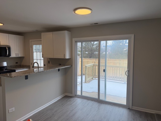 588 Nantucket Way, Unit 2 Island Lake, IL 60042 - Photo 8 of 29 a kitchen with a window a sink and a counter top space