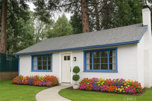 a front view of a house with a garden