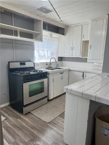 a kitchen with cabinets appliances and a sink