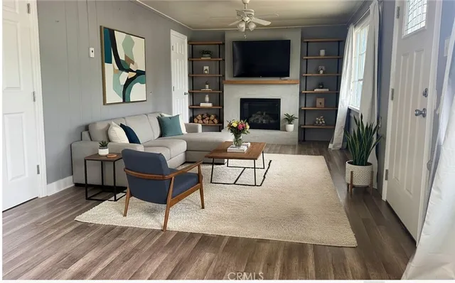 a living room with furniture a fireplace and a flat screen tv