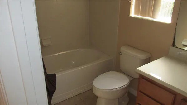 a white toilet sitting next to a bath tub