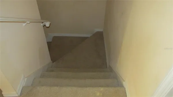 a view of a small space with wooden door