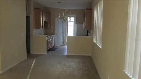 a view of hallway with furniture and a window