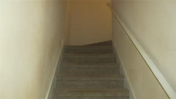 a view of staircase with white walls