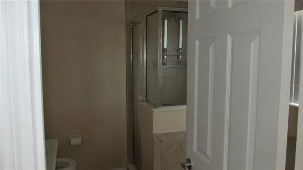 a bathroom with a glass door shower