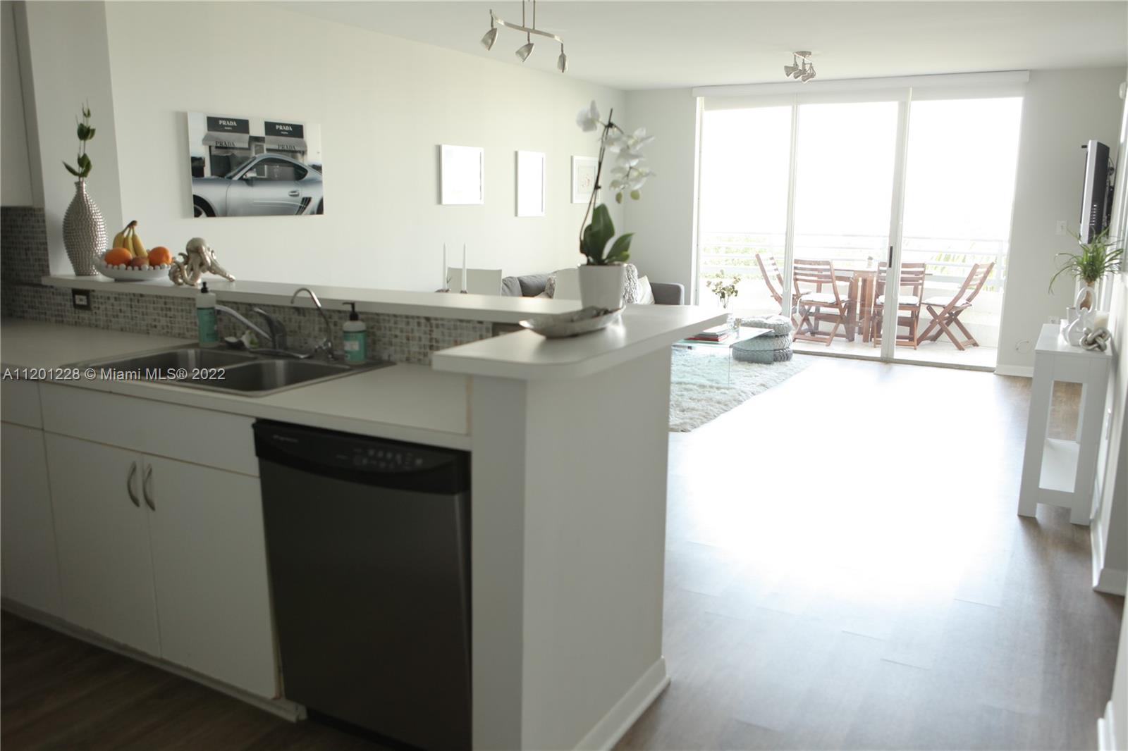 1401 Bay Road, Unit 507 Miami Beach, FL 33139 - Photo 3 of 10 a kitchen with a sink and a window