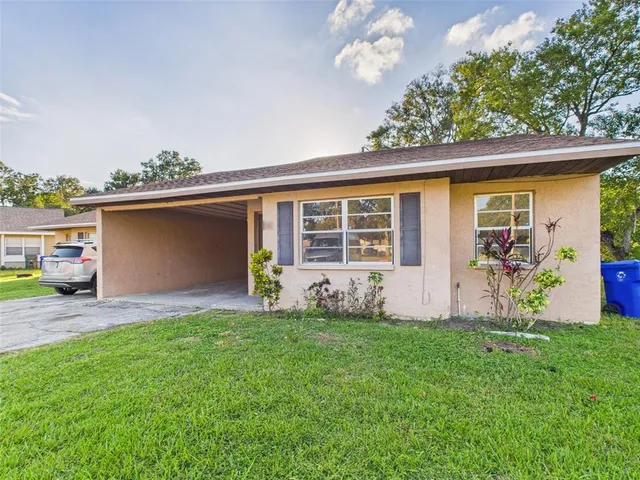 a front view of a house with a garden and yard