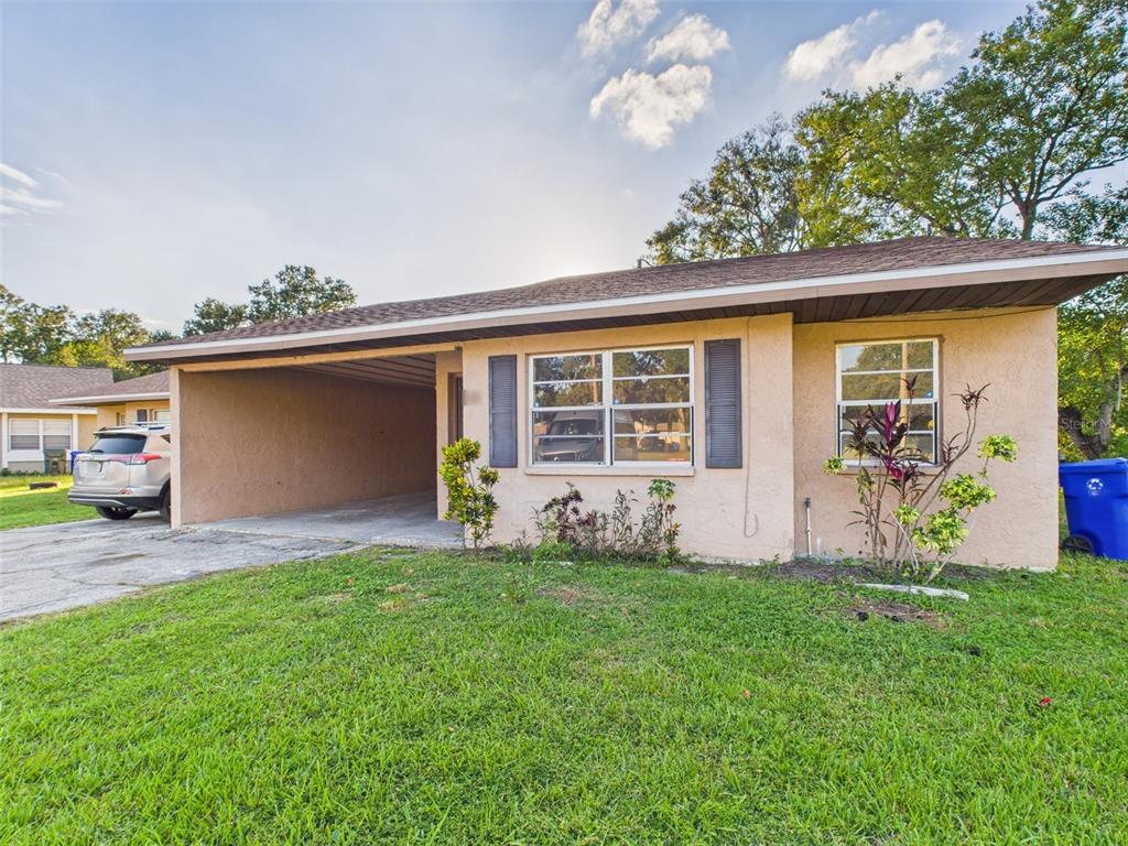 a front view of a house with a garden and yard