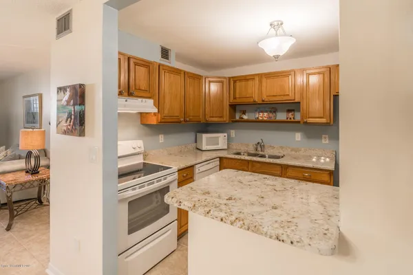 a kitchen with a stove a sink and a refrigerator