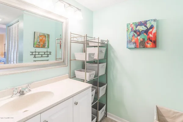 a bathroom with a sink a vanity and a shower