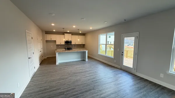 a view of kitchen with cabinets and wooden floor