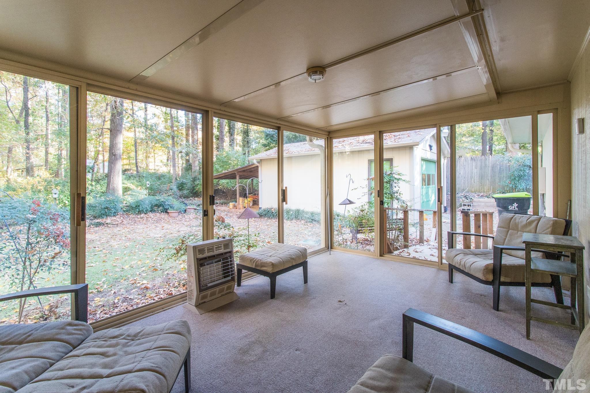 6304 Garrett Road Raleigh, NC 27606 - Photo 13 of 15 a living room with furniture and floor to ceiling windows