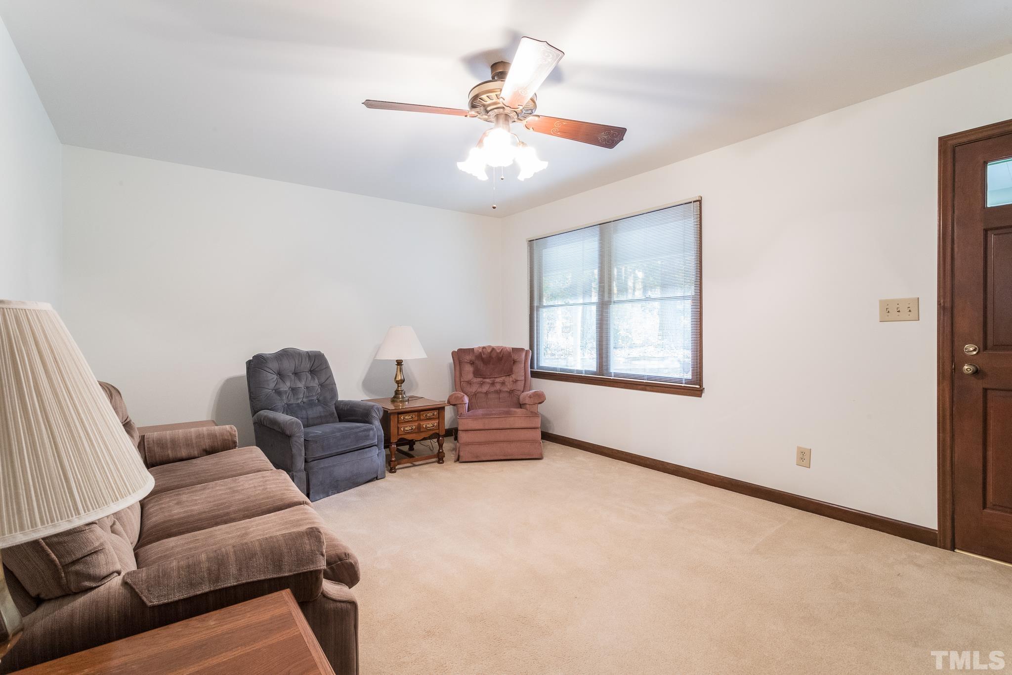 6304 Garrett Road Raleigh, NC 27606 - Photo 3 of 15 a bedroom with furniture and a window