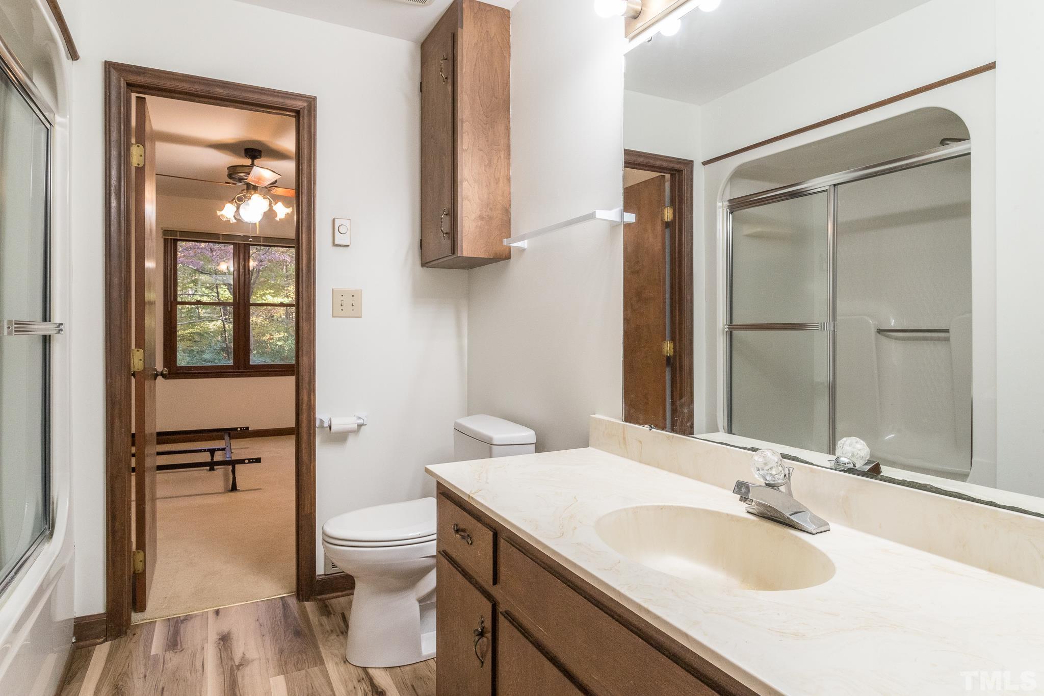 6304 Garrett Road Raleigh, NC 27606 - Photo 10 of 15 a bathroom with a sink toilet and shower