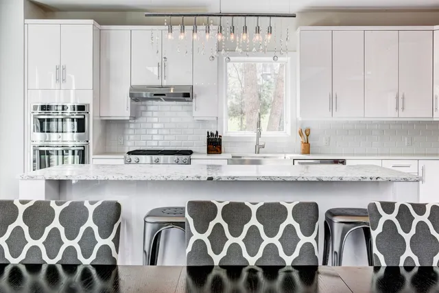 a kitchen with stainless steel appliances granite countertop a sink and a cabinets