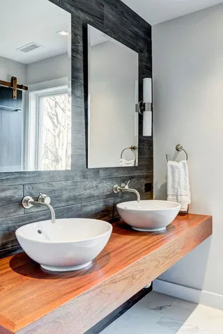 a bathroom with sinks and a mirror