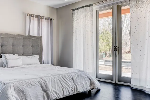 a bedroom with a bed and a window