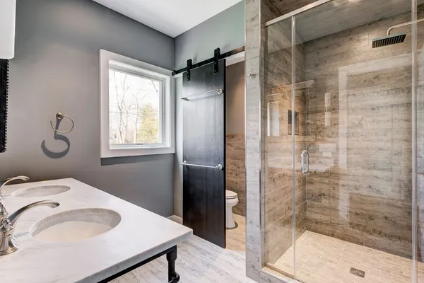 a bathroom with a sink toilet and shower