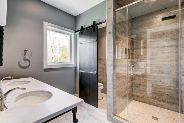 a bathroom with a sink toilet and shower