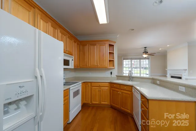 a kitchen with a sink a counter top space stainless steel appliances and cabinets