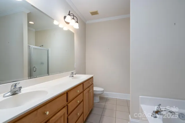 a bathroom with a double vanity sink a mirror and a